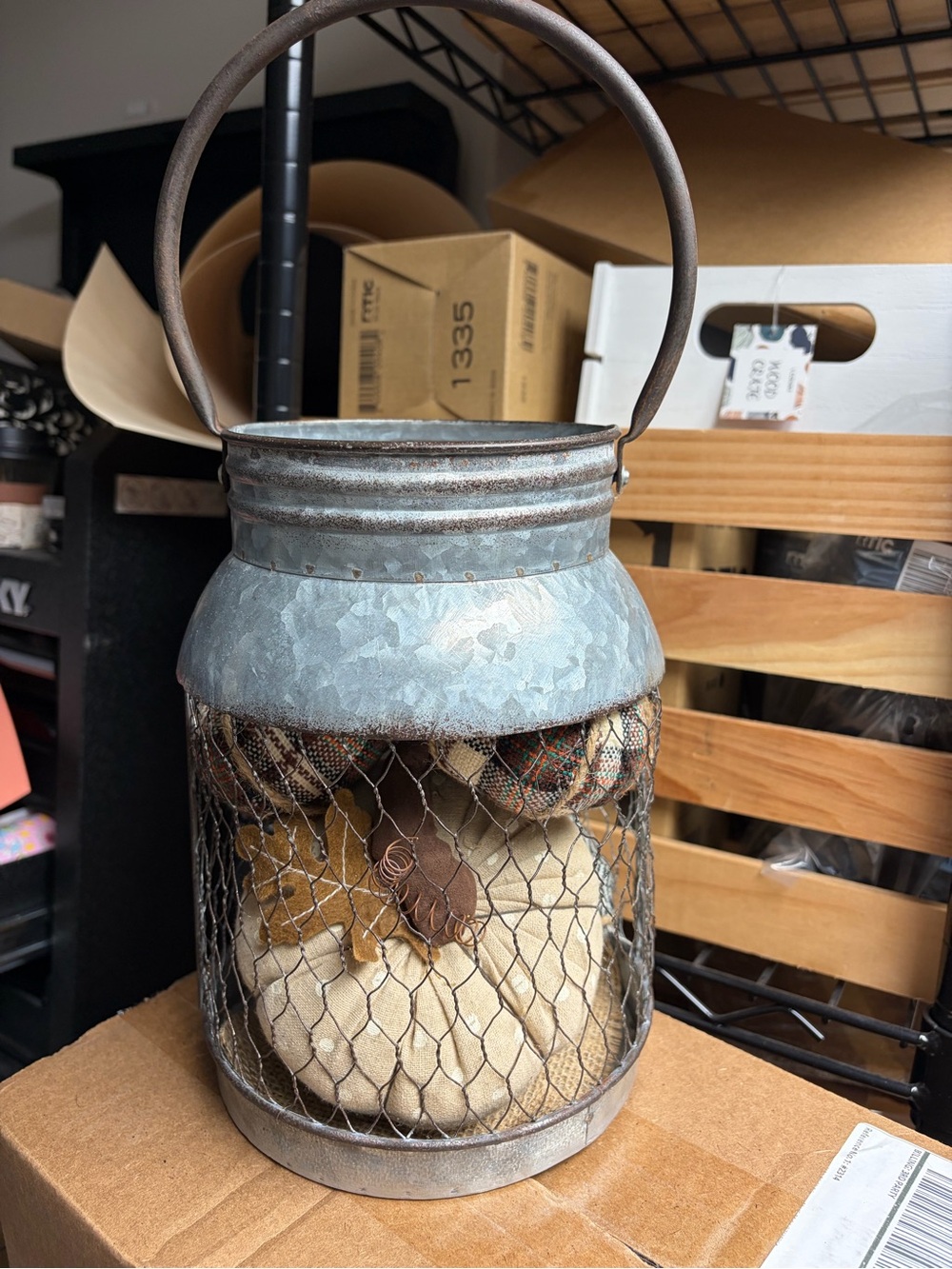 Rustic Galvanized Metal Lantern with Brown Handle and Decorative Fill of pumpkin